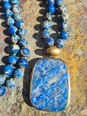 Long necklace with natural blue sedimentary stones and a lazurite pendant.