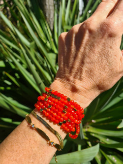 Long necklace of natural orange stones and golden hematite pieces