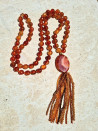 Long necklace of orange agates with pendant and tassel