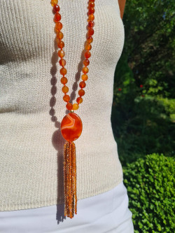 Long necklace of orange agates with pendant and tassel