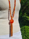 Long necklace of orange agates with pendant and tassel