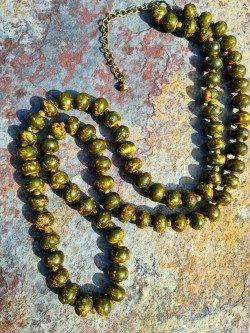 Long necklace of khaki-dyed bone with yellow spots
