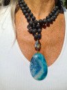 Long black lava necklace with natural agate pendant