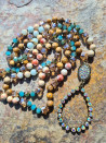 Long necklace of agate and crystals with a handmade oval pendant