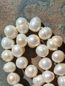 Long handmade necklace of natural baroque pearls in various shades