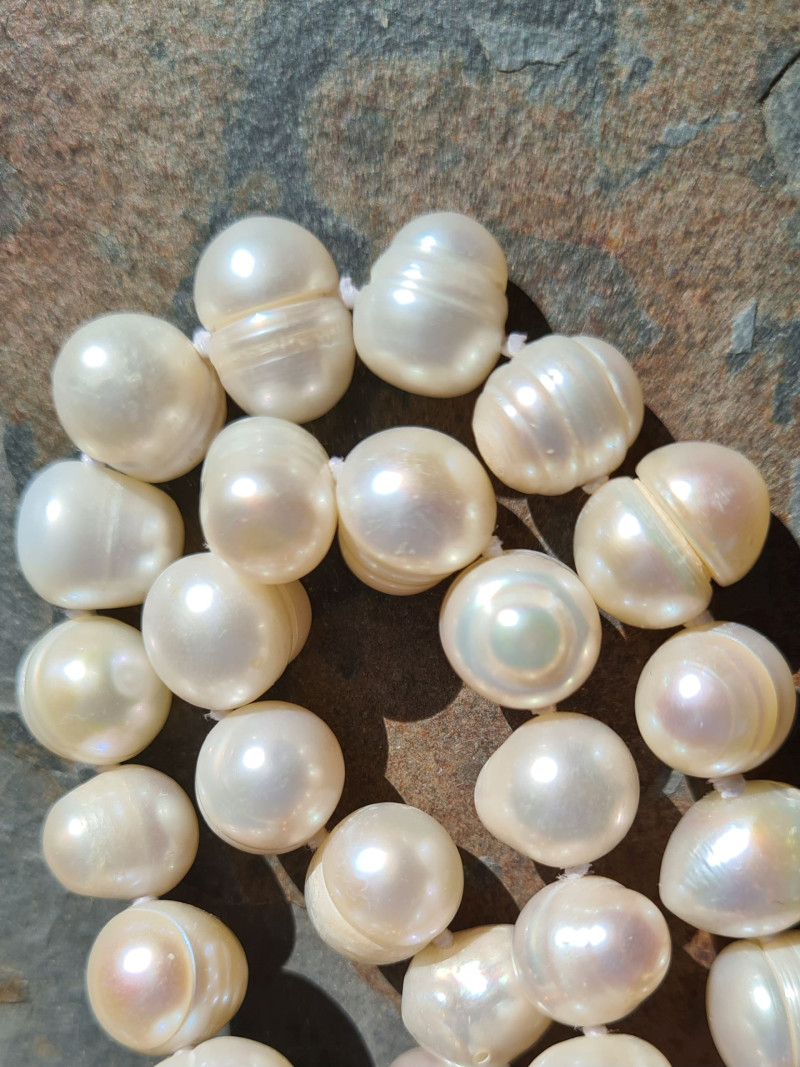 Long handmade necklace of natural baroque pearls in various shades
