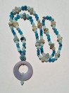 Long necklace of blue and gray agates with agate circle pendant