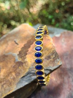 Rigid gold bracelets with colorful cubic zirconia