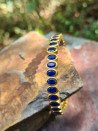 Rigid gold bracelets with colorful cubic zirconia
