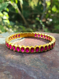 Rigid gold bracelets with colorful cubic zirconia