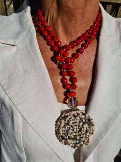 Long necklace of red agates with crystal flower pendant
