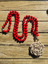 Long necklace of red agates with crystal flower pendant