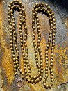 Very long necklace with gold-plated wooden beads and a lobster clasp