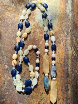 Cord-style necklace of oval blue and ochre agates with crystals